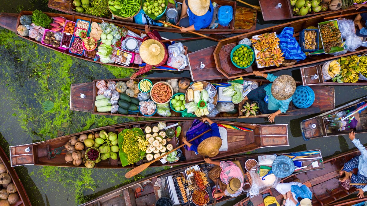 Aerial view famous floating market in Thailand, Damnoen Saduak f Aerial view famous floating market in Thailand, Damnoen Saduak floating market, Farmer go to sell organic products, fruits, vegetables and Thai cuisine, Tourists visiting by boat, Ratchaburi, Thailand